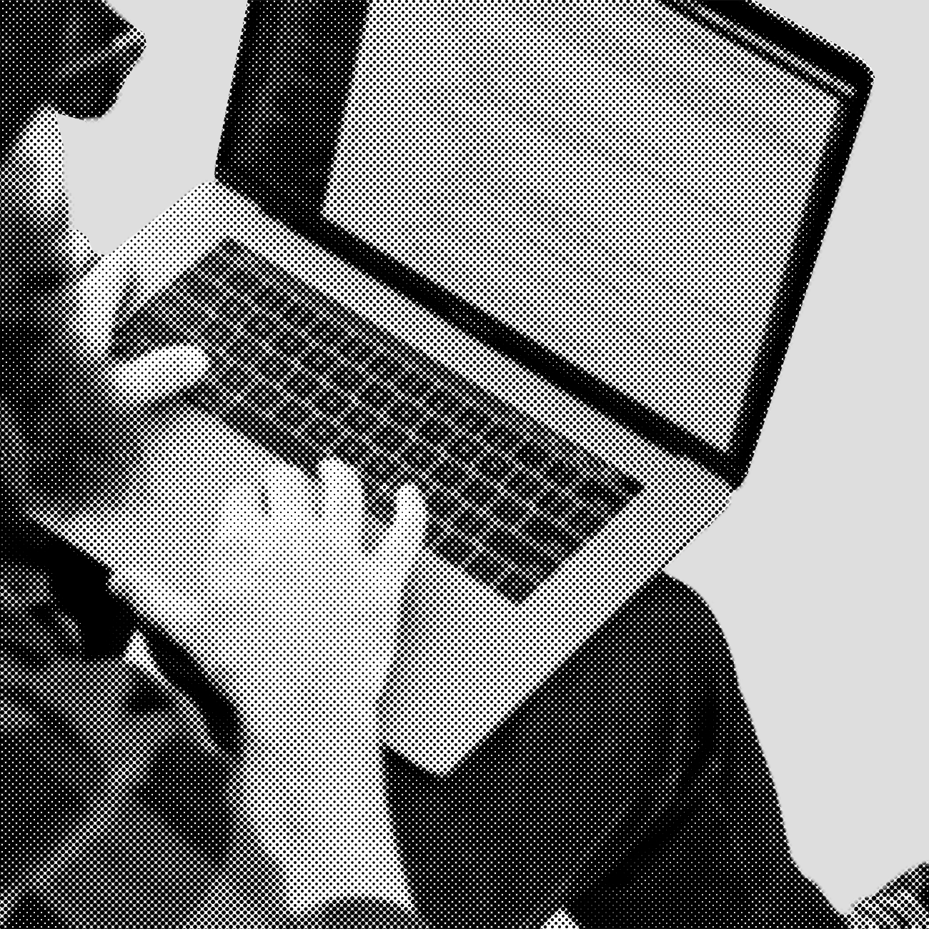 A shot over-the-shoulder of a developer working on a laptop.