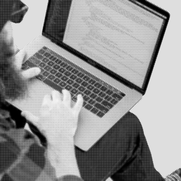 A shot over-the-shoulder of a developer working on a laptop.