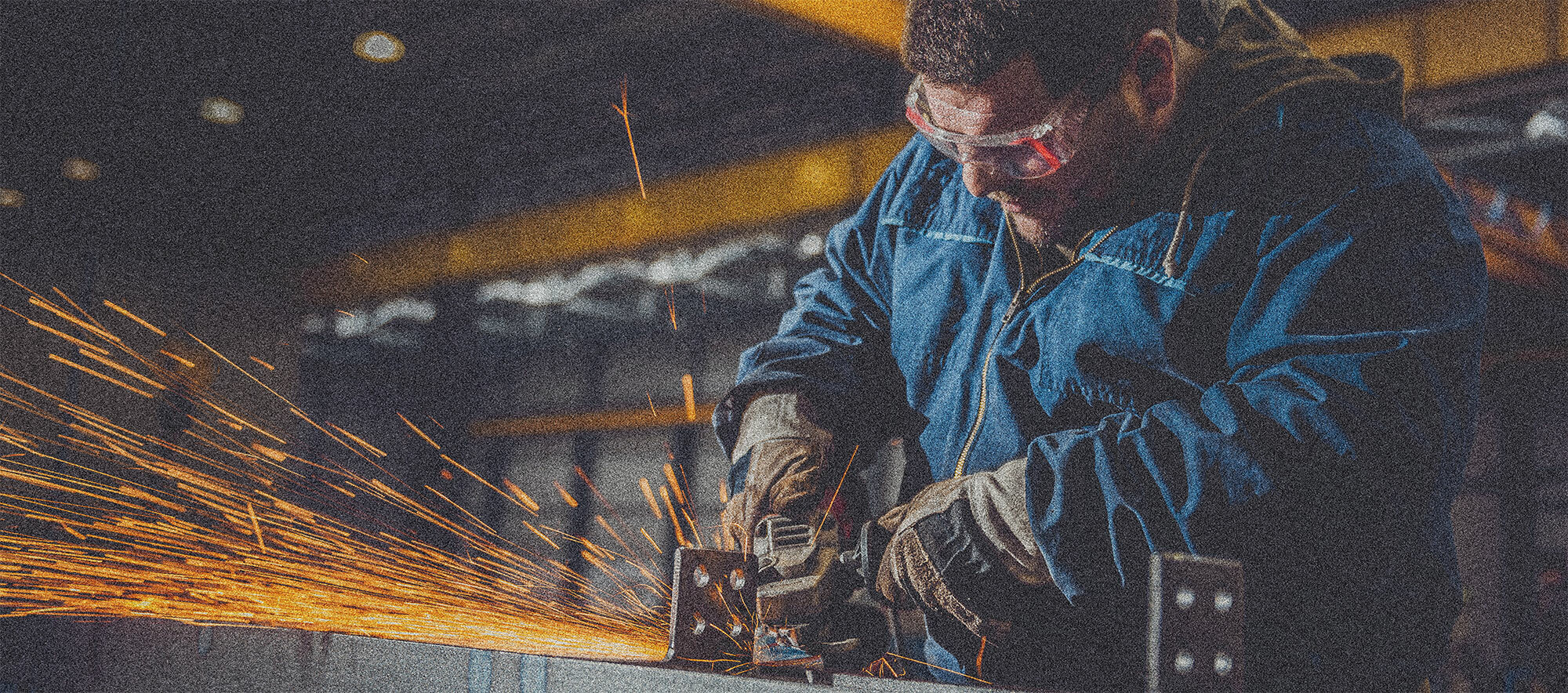 Worker using angle grinder