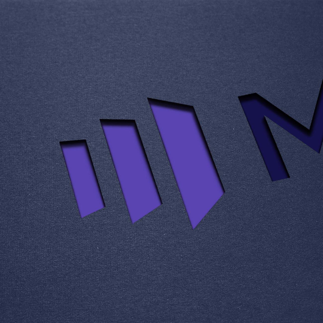The Marketo logo diecut out of black paper.
